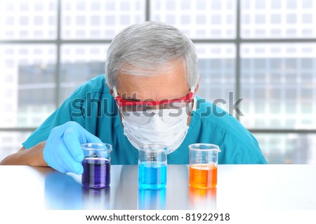 Scientist in modern laboratory with protective mask and goggles examining laboratory beakers filled with different chemicals. Horizontal format.