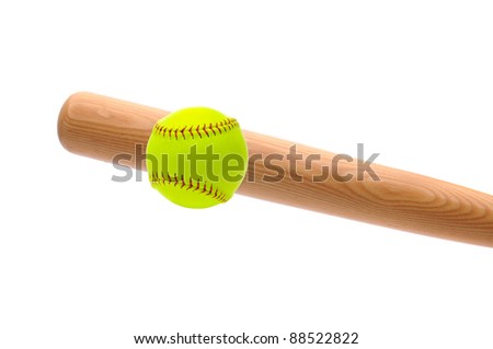 Wood bat hitting a yellow softball over a white background.