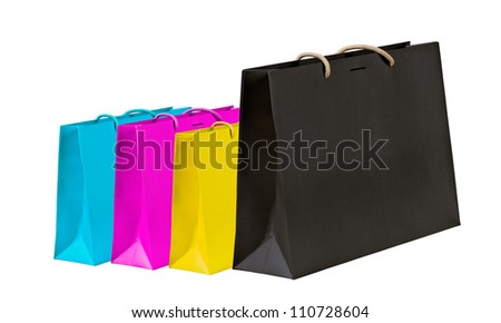 Cyan, magenta, yellow and black shopping bags on white.
