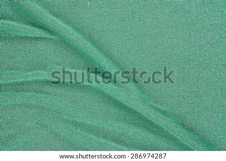 Green fabric (detail of golden jersey dress)