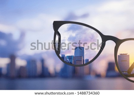 Modern bright city view through eyeglasses. Blurry background. Vision concept Foto d'archivio © 