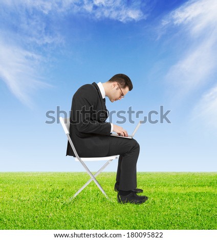 businessman  with computer on field