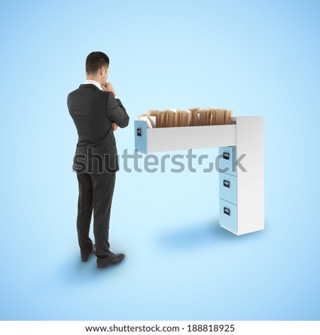 businessman looking at file cabinet with  documents