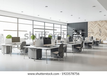 Eco style interior design in modern open space office with grey tables and chairs, wooden decor wall and concrete floor. 3D rendering