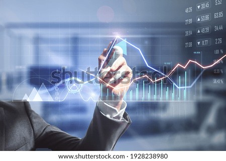 Businessman hand writing on digital screen with financial trade market graphs, diagram and forex chart. Double exposure