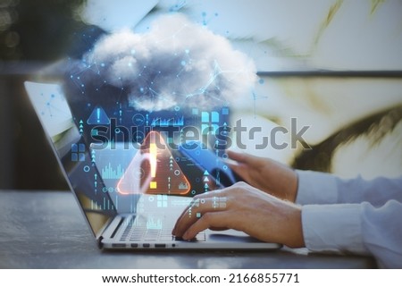 Close up of businessman hands using laptop and smartphone on desktop with coffee cup and abstract hologram raining cloud on blurry background. Data, information leak, security and theft concept.  Foto stock © 