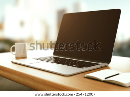 workspace with modern laptop at sunrise