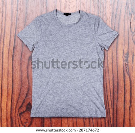 Blank gray t-shirt on a wooden surface