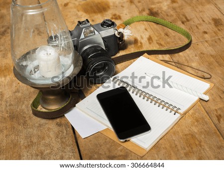 blank cell phone, diary and old photo camera