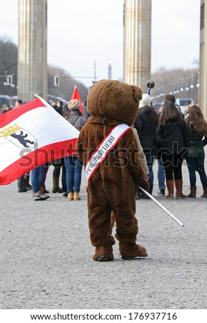 BERLIN, GERMANY - FEBRUARY 14: Man dressed as a bear at the Branderburger Tor, on February 14, 2014 in Berlin, Germany. Bear is a symbol of Berlin.