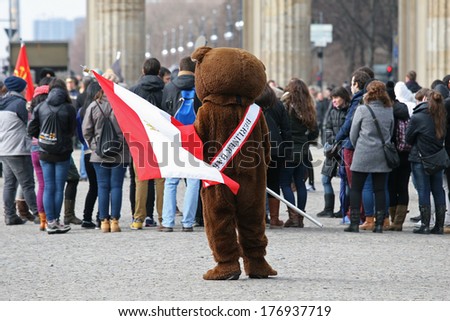 BERLIN, GERMANY - FEBRUARY 14: Man dressed as a bear at the Branderburger Tor, on February 14, 2014 in Berlin, Germany. Bear is a symbol of Berlin.