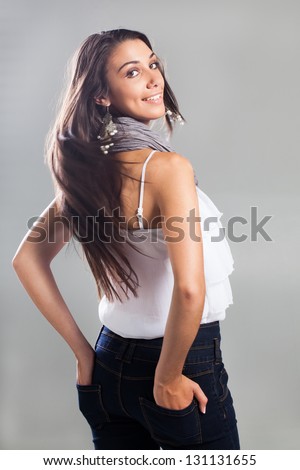 A young model with long brown hair are being photographed in a studio.