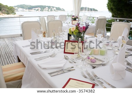 Wedding table arrangement with flowers and seating list