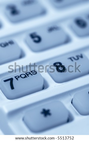 Close-up of Phone Keypad. Very shallow depth of field. Focus on letters PQRS. Visible texture of plastic.