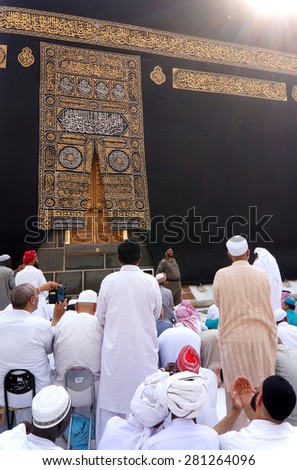 MECCA,SAUDI ARABIA-CIRCA MAY 2015: Muslims getting ready to pray in front of Kaaba door at Masjidil Haram on MAY,2015 in Makkah,Saudi Arabia.Muslims all around the world come here doing umrah and hajj