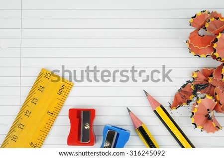 pencil, ruler,pencil shavings on lined paper