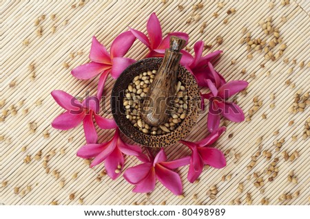 mortar and pestle with red flowers