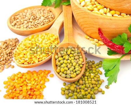 Lentil bean in wooden plate with spice, isolated on white, food photo