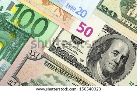 Euro banknotes and dollars of USA overlapping each other