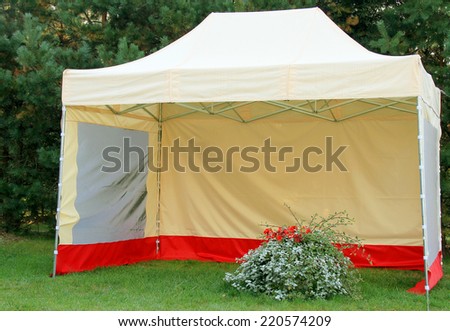 Big open tent with flowers in outside park area