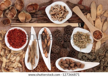Traditional chinese herbal medicine selection over papyrus background.