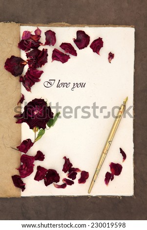 Old fashioned vintage hemp notebook, I love you phrase, ink pen and red rose with petals over lokta paper background.