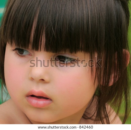 The face of little girl with rosebud shaped lips.
