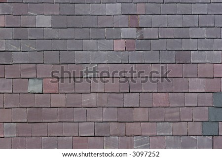 Wall of grey and smoky purple welsh slates. Slates are often used in the building industry to cover the sides of buildings to protect them from driving rain.