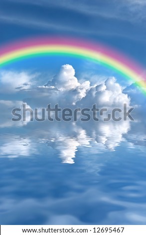 Abstract of a blue sky and rainbow with dark cumulus storm clouds reflected over rippled water.
