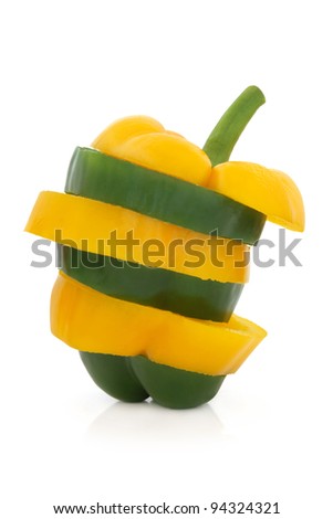 Green and yellow pepper vegetable in abstract layered slices isolated over white background.