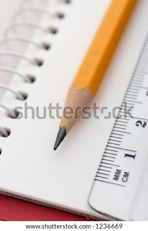 pen an ruler on white pages of paper