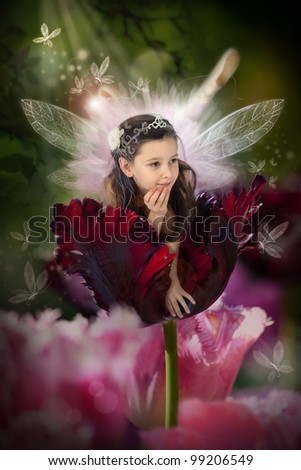 Sweet little fairy in a blossom red tulip