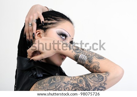 portrait of young tattooed stylish woman on white background
