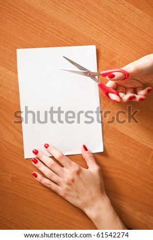 Hands cutting a piece of paper