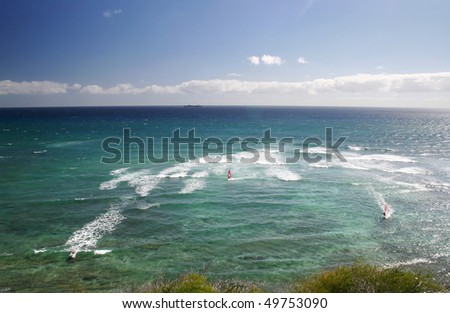 A view of people play surfing in Hawaii sea side.