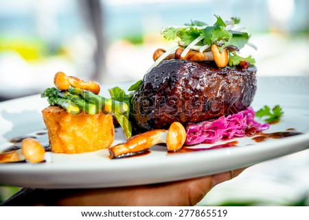 Meat with potatoes and asparagus on a white plate. The Restaurant