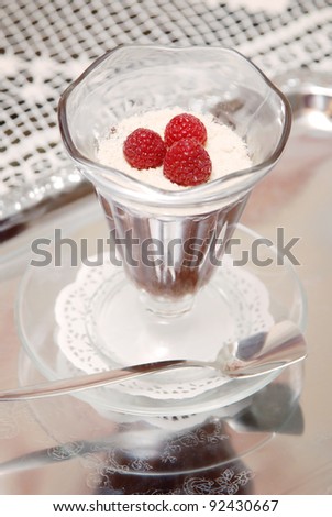 Frozen dessert in glass cup with raspberry