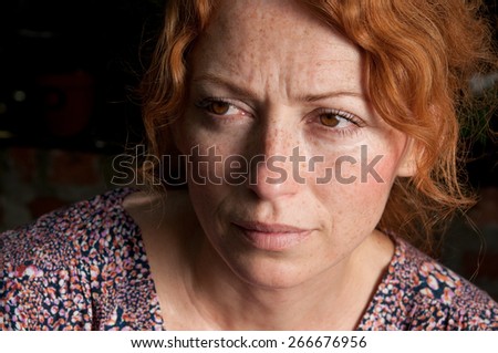 red hair freckled melancholy woman
