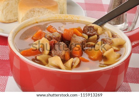 A bowl of vegetable beef soup with noodles