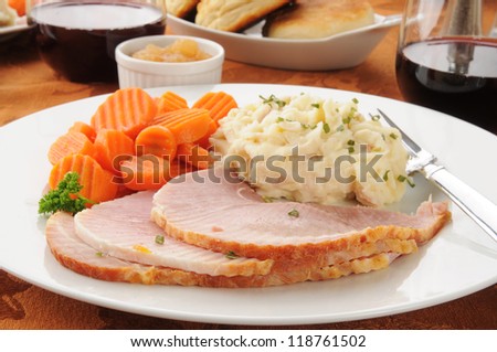 Ham dinner with mashed potatoes, carrots and red wine