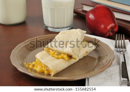 Sausage, egg and cheese burrito with milk as an after school snack