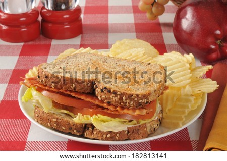 A bacon, lettuce and tomato sandwich on whole grain and seed bread