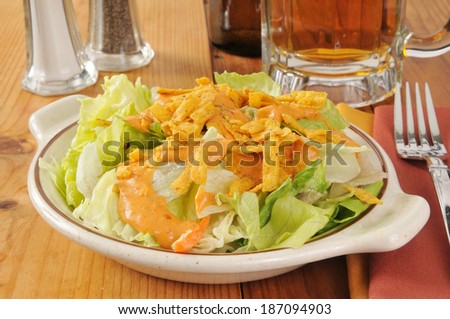 A garden salad with southwestern dressing and fried tortilla strips with beer