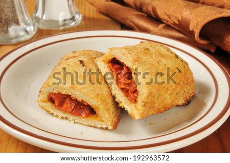 Hot pizza rolls or pockets broken open on a plate