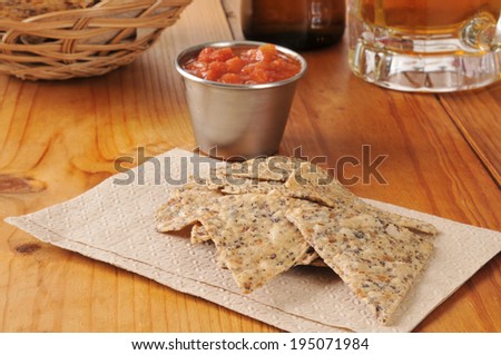Rice and bean tortilla chips with salsa and beer