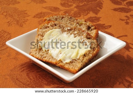 Slices of buttered zucchini bread in a small white dish