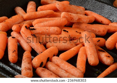 Grilled baby carrots in a cast iron skillet
