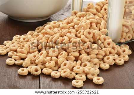 Oat rings cereal spilling out of a glass canister