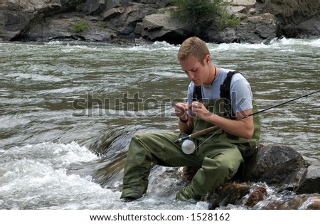 A fisherman in a stream