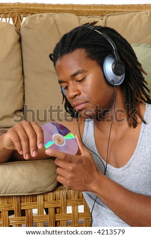 A handsome young man listening to a new CD
